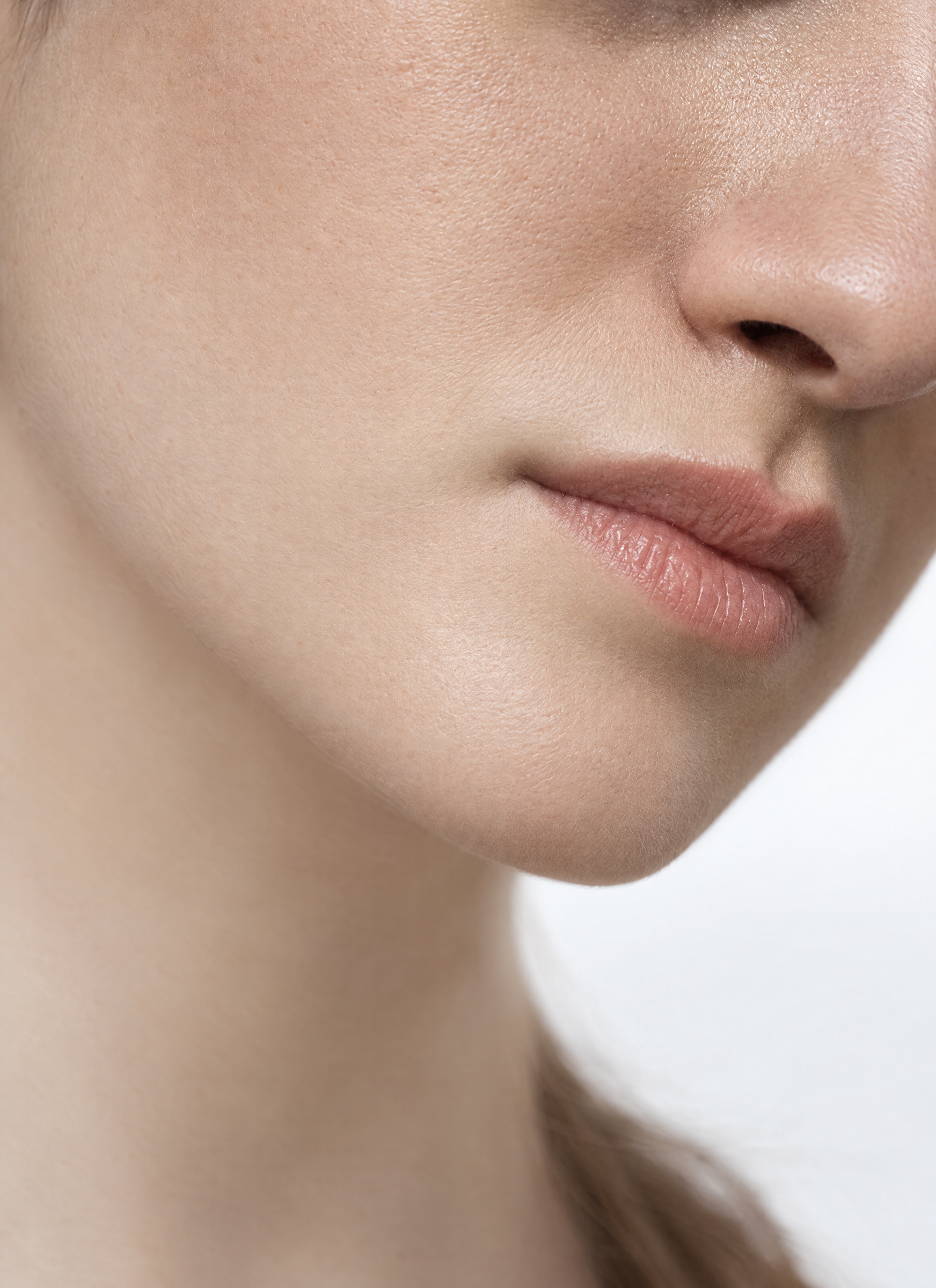 Soft close-up of a woman's lips and jawline