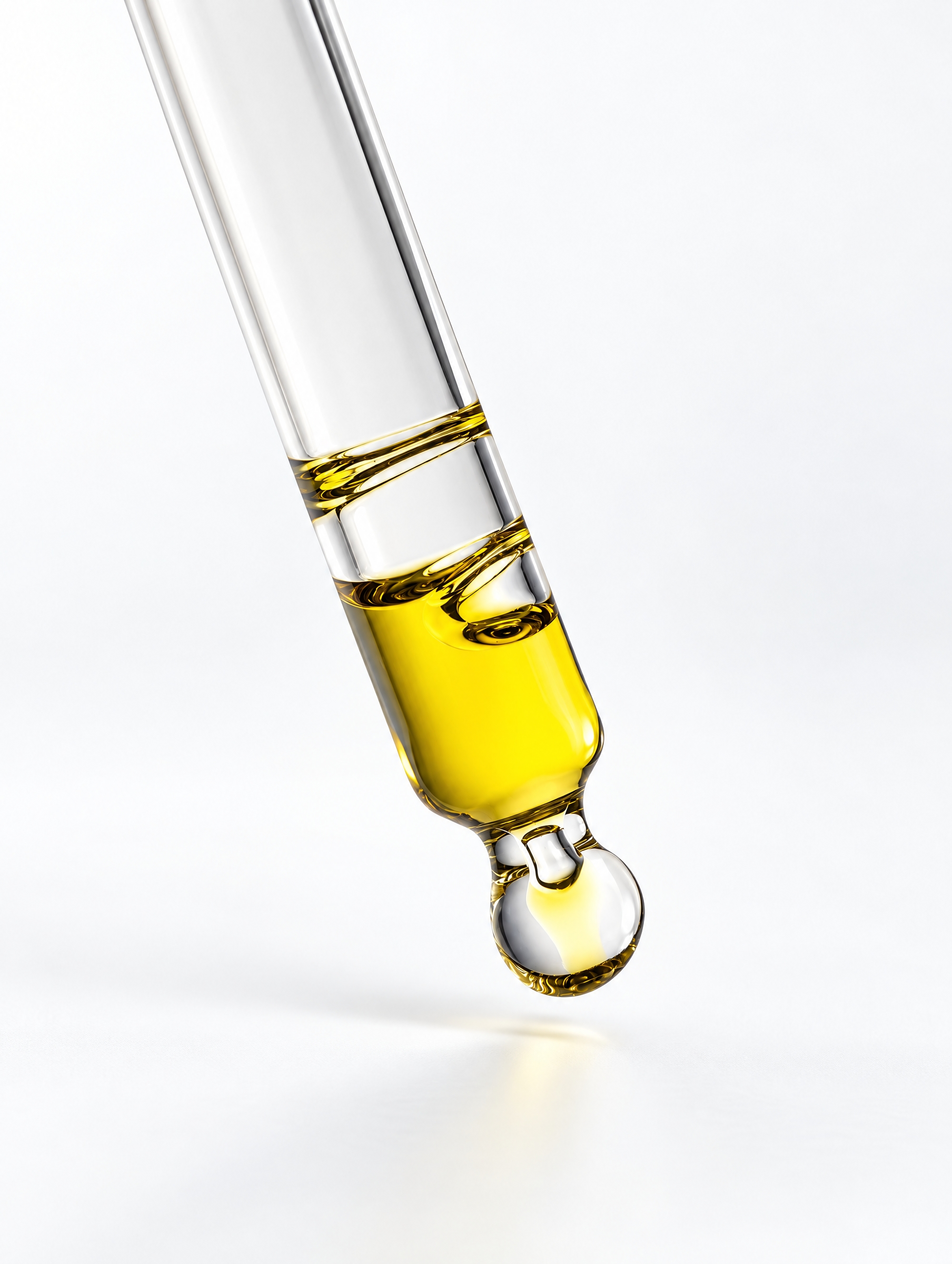 A serum dropper above a bottle of medical-grade skincare