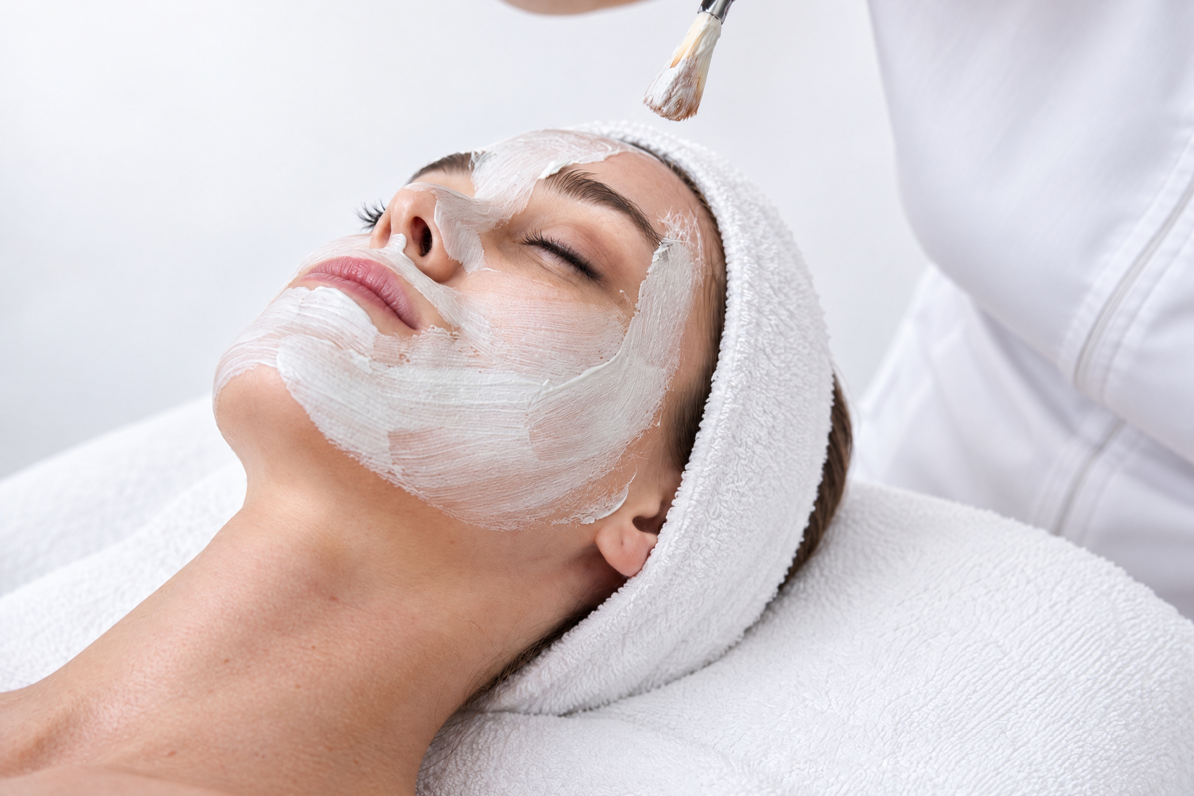 Client resting with a hydrating cream on her face