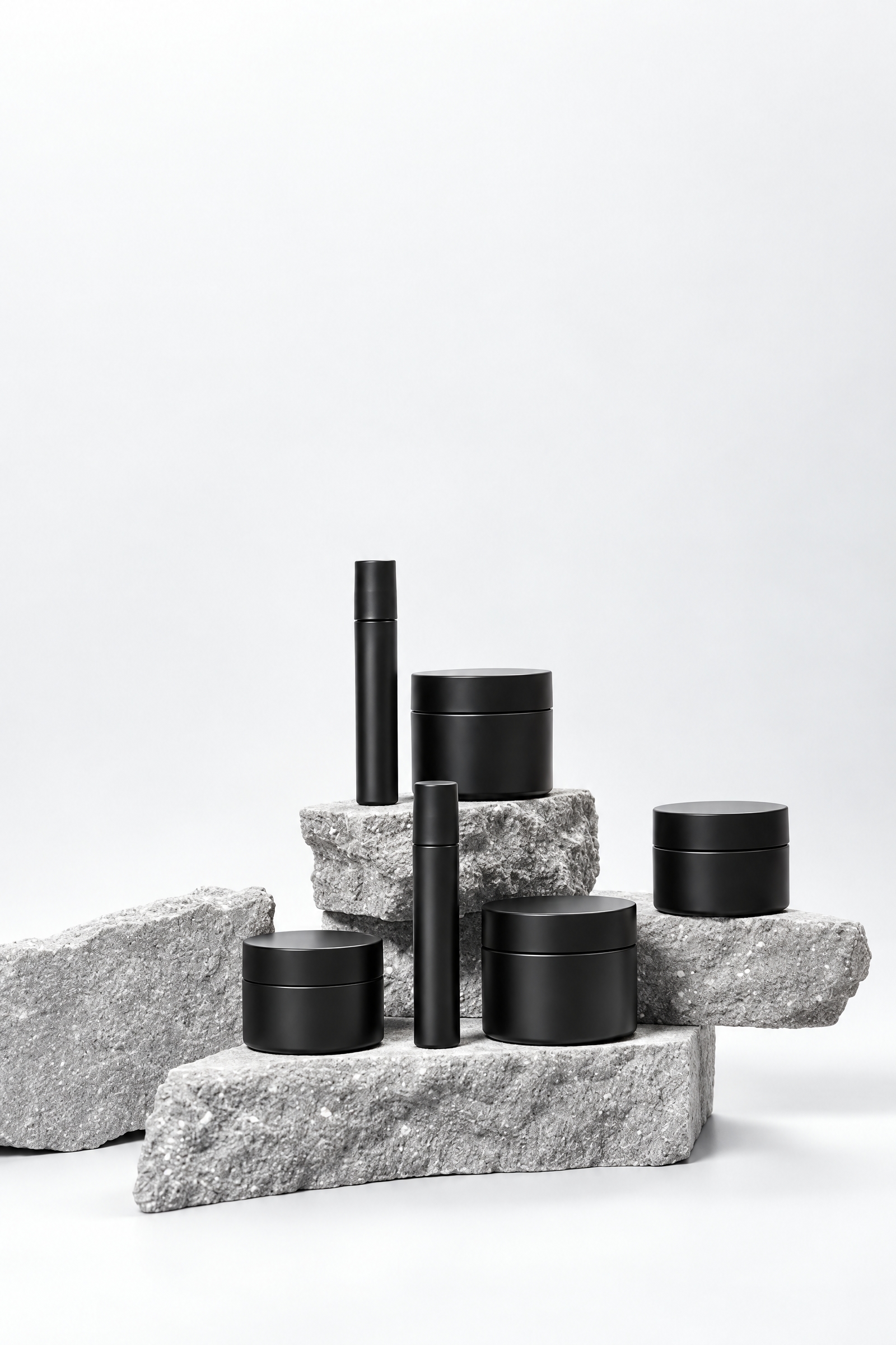 A set of dark skincare containers arranged together